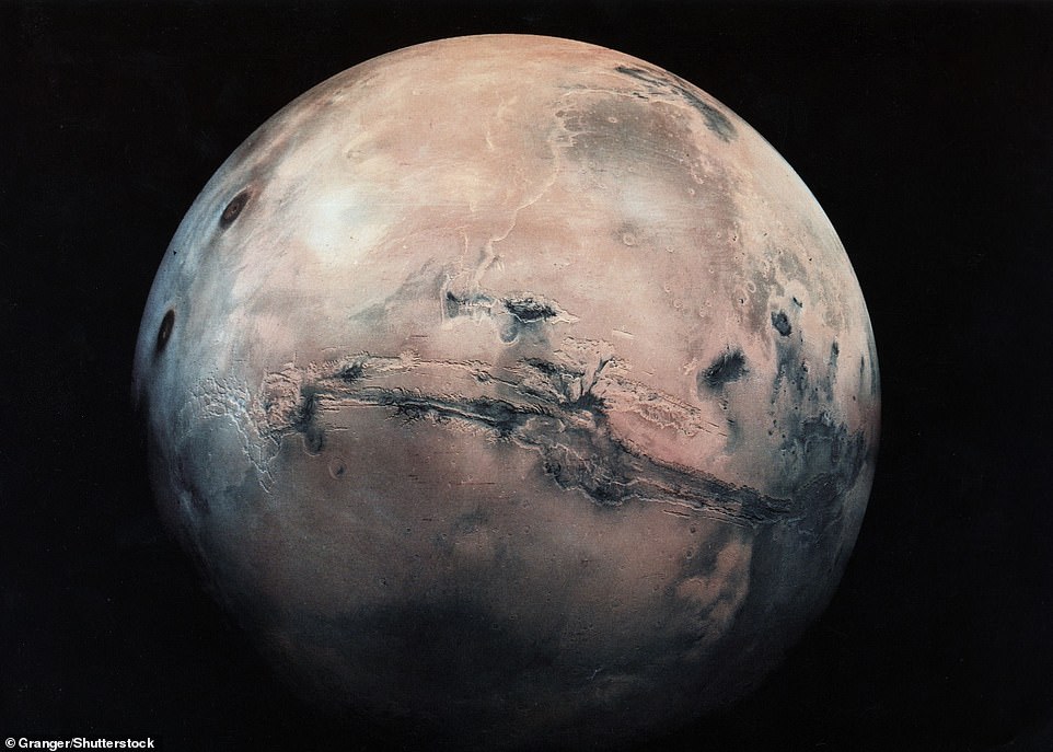 The Red Planet's vast Marine Valley - which spans nearly a quarter of the planet's circumference - can be seen above (center) in this image from the Granger collection.