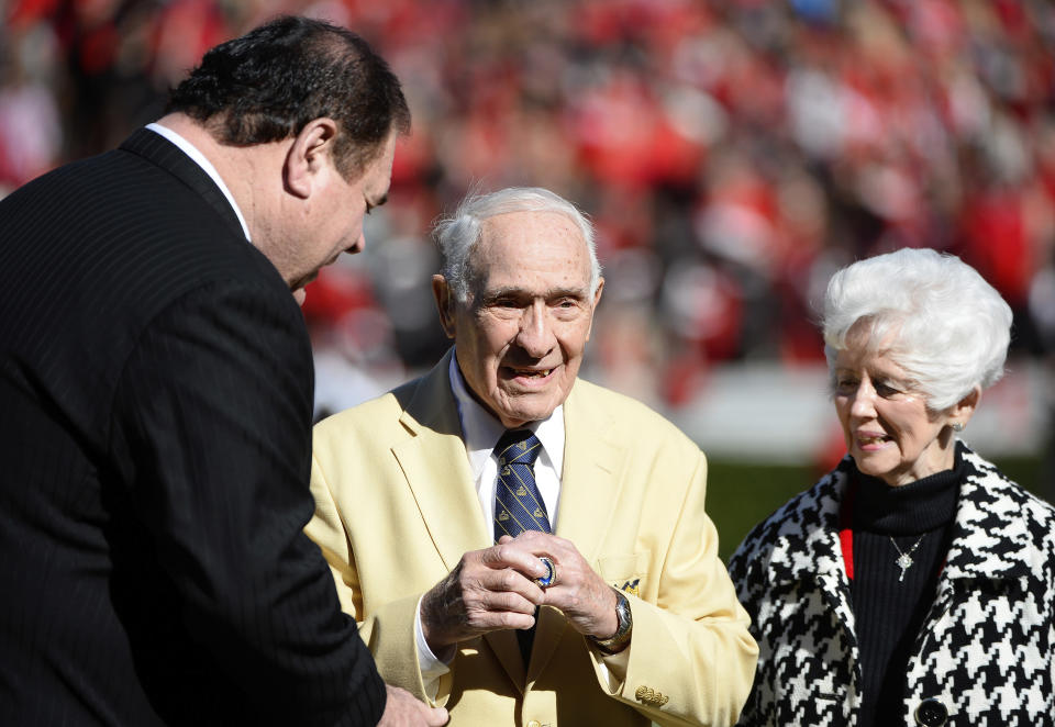FILE - Former Georgia player Charley Trippi, a two-time All-Amercian, receives a College Football Hall of Fame ring during the first half of an NCAA college football game between Georgia and Georgia Tech On November 29, 2014 in Athens, Ga Trippi, a Heisman Trophy finalist in Georgia who went on to lead the Cardinals to their last NFL championship in 1947, died on Wednesday, October 19, 2022. He was 100 years old.  (AP Photo/David Tulis, File)