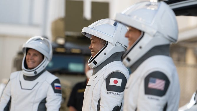 NASA astronauts Josh Cassada, left, and Nicole Mann, second from left, Japan Aerospace Exploration Agency (JAXA) astronaut Koichi Wakata, second from right, and Roscosmos cosmonaut Anna Kikina, right, wearing spacesuits, appear as they depart.  Neil A. Armstrong Operations and Checkout Building for Launch Complex 39A during a pre-mission review of Crew-5, Sunday, Oct. 2, 2022, at NASA's Kennedy Space Center in Florida.