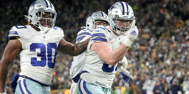 Dallas Cowboys' Qadree Ollison, #30, Luke Gifford, #57, and CJ Goodwin, fullback, celebrate after stopping on a Green Bay Packers punt return during the second half of a game in NFL football on Sunday, Nov. 13, 2022, in Green Bay, Wisconsin.