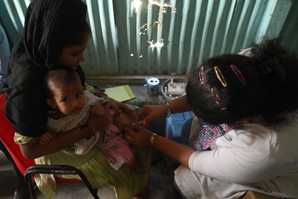 A child receives a vaccine following an outbreak of measles in India, November 23, 2022.