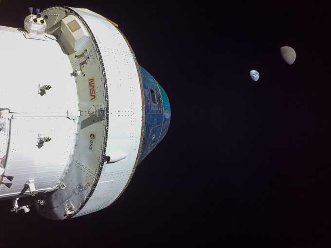 Orion's capsule against the expanse of space with the earth and moon as a tiny semicircle in the distance