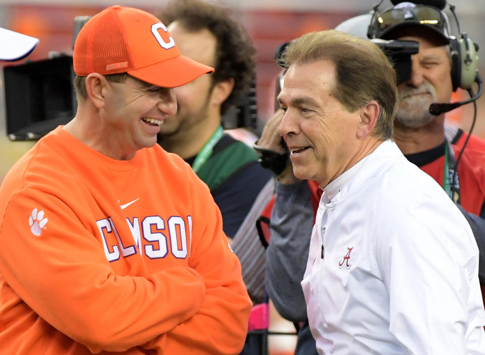 Clemson Tigers coach Dabo Swinney (left) and Alabama Crimson Tide coach Nick Saban smile on the court before the 2019 CFP title game. (Kirby Lee - USA TODAY Sports)