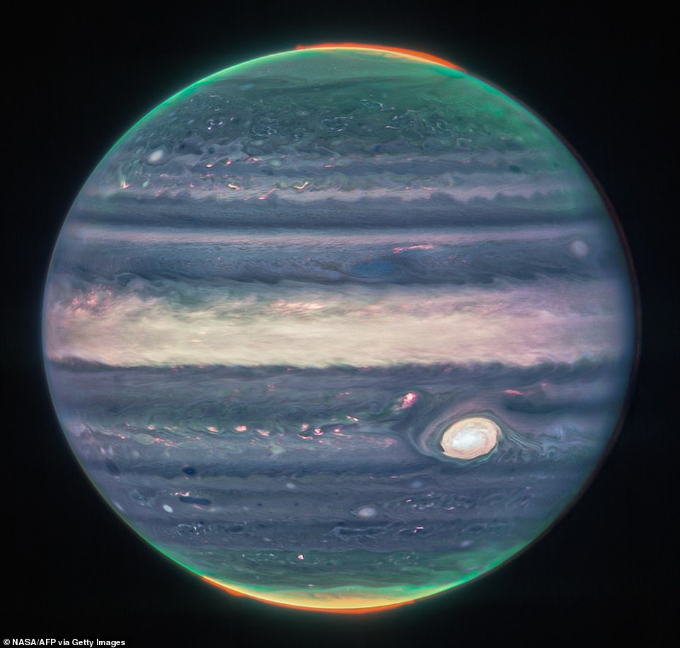 A real beauty: JWST shared new images of Jupiter in 2022 that capture its stunning auroras  glowing at the gas giant's north and south poles. The auroras are caused by fluctuations in the planet's magnetic field. As Jupiter rotates, it drags its magnetic field bombarded by particles of solar wind