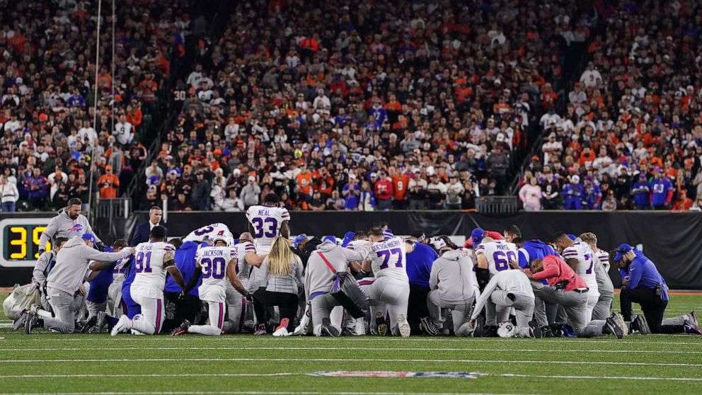 PHOTO: Buffalo Bills players gather and pray after teammate Damar Hamlin collapsed on the field after making a tackle against the Cincinnati Bengals during the first quarter Jan. 2, 2023 in Cincinnati.