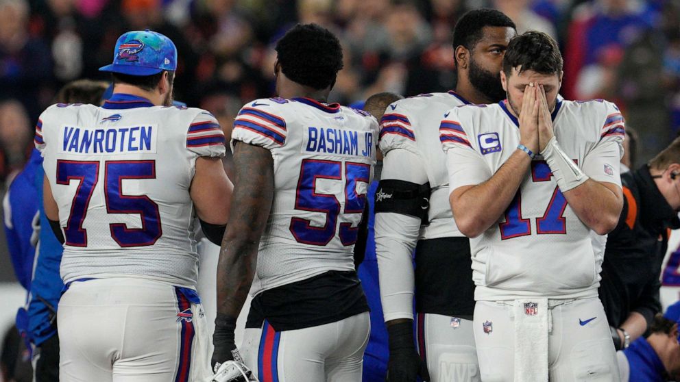 PHOTO: Buffalo Bills quarterback Josh Allen pauses as Damar Hamlin is examined after collapsing during the first half of an NFL football game against the Cincinnati Bengals on Jan. 2, 2023, in Cincinnati.