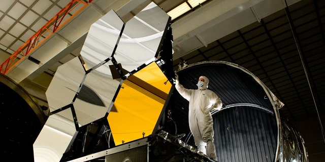 Ball Aerospace lead optical test engineer Dave Chaney inspects the six parts of the primary mirror, critical elements on NASA's James Webb Space Telescope, before a cryogenic test in the X-ray & Cryogenic Facility at NASA's Marshall Space Flight Center in Huntsville, Ala.