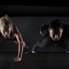 This shows a man and a woman doing push-ups