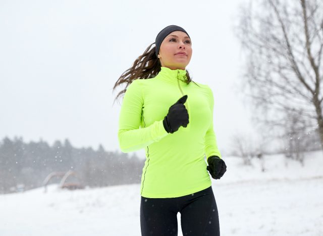 woman on a snowy winter run to lose weight while on vacation
