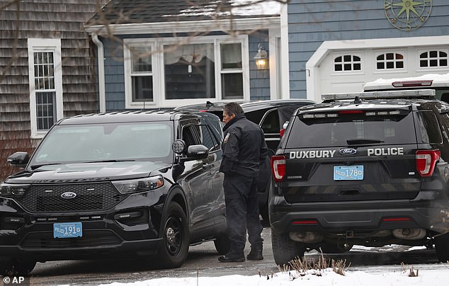 Duxbury Police work at the scene where the two children were found dead. The third died later