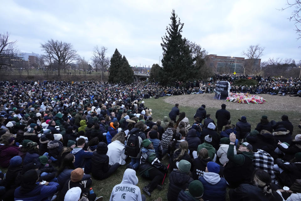 Mourners sit at The Rock on the grounds of Michigan State University in East Lansing, Michigan, Wednesday, Feb. 15, 2023. Alexandria Verner, Brian Fraser and Arielle Anderson were killed and several other students remain in critical condition after that a gunman opened fire on the campus of Michigan State University on Monday evening.  (AP Photo/Paul Sancya)