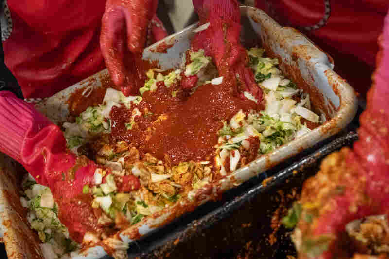 Spicy red pepper paste is mixed in with scallions, garlic, and salt-brined cabbage.